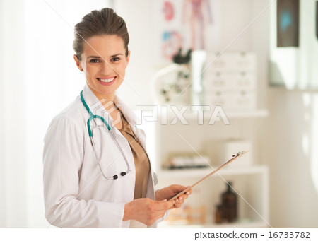 Portrait of doctor woman with clipboard in office Portrait of doctor woman with clipboard in office 16733782