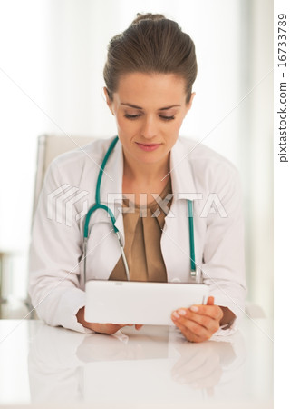 Doctor woman using tablet pc in office Doctor woman using tablet pc in office 16733789