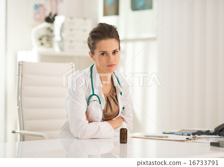 Portrait of doctor woman with medicine bottle in office Portrait of doctor woman with medicine bottle in office 16733791