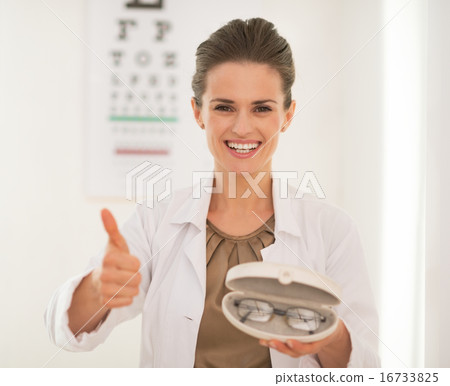 Ophthalmologist doctor woman with eyeglasses showing thumbs up i 16733825
