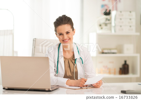 Happy medical doctor woman working in office 16733826