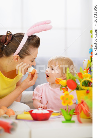 Mother and baby eating Easter egg Mother and baby eating Easter egg 16733956