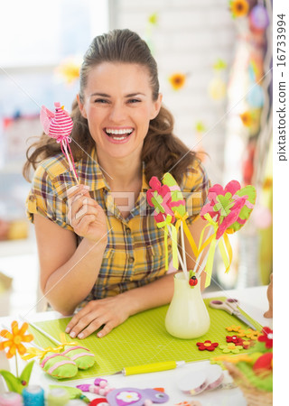 Smiling young woman preparing for easter Smiling young woman preparing for easter 16733994