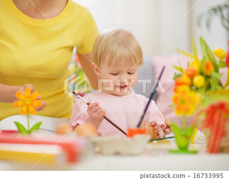Happy mother and baby making Easter decorations Happy mother and baby making Easter decorations 16733995