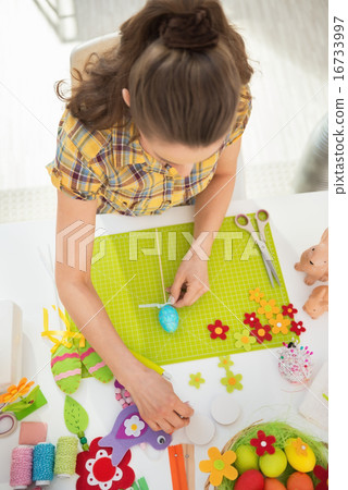 Young woman making easter decoration Young woman making easter decoration 16733997