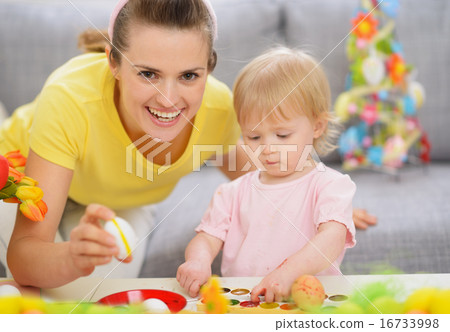 Happy mother and baby making Easter decorations Happy mother and baby making Easter decorations 16733998