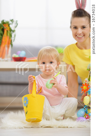 Baby playing with Easter decorations Baby playing with Easter decorations 16734018