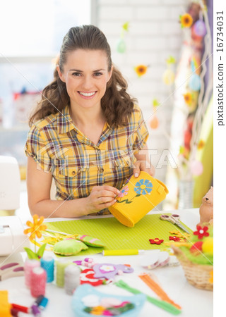 Portrait of happy young woman making easter basket in studio Portrait of happy young woman making easter basket in studio 16734031