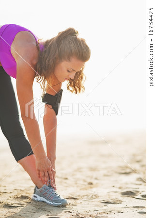 Fitness young woman stretching outdoors 16734425