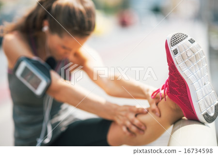 Closeup on fitness young woman stretching outdoors 16734598