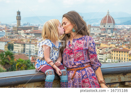 Mother and baby girl kissing against panoramic view of florence, Mother and baby girl kissing against panoramic view of florence, 16735186
