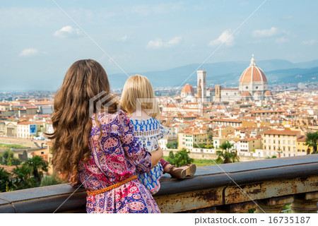 Mother and baby girl looking on panoramic view of florence, ital Mother and baby girl looking on panoramic view of florence, ital 16735187