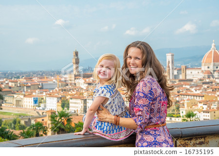 Portrait of happy mother and baby girl against panoramic view of Portrait of happy mother and baby girl against panoramic view of 16735195