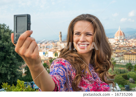Happy young woman making selfie in front of panoramic view of fl Happy young woman making selfie in front of panoramic view of fl 16735206
