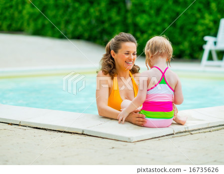 Happy mother and baby girl in swimming pool Happy mother and baby girl in swimming pool 16735626
