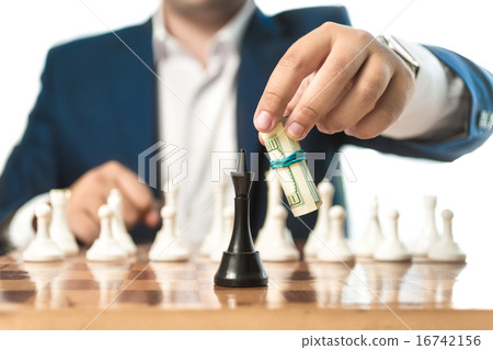 businessman in suit make move with dollars in ches 16742156