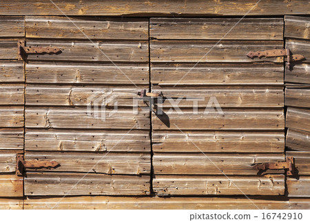 Old rural brown wooden gate with padlock 16742910