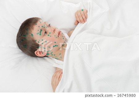 sick boy in white bed 16745980