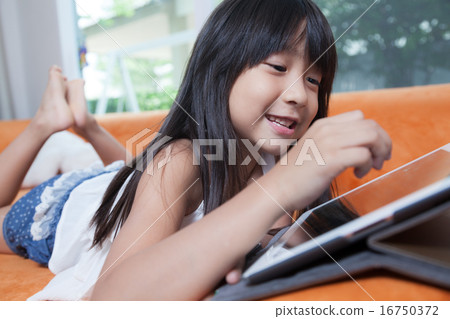 Girl playing with tablet. Girl playing with tablet. 16750372
