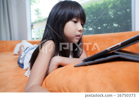 Girl playing with tablet. 16750373