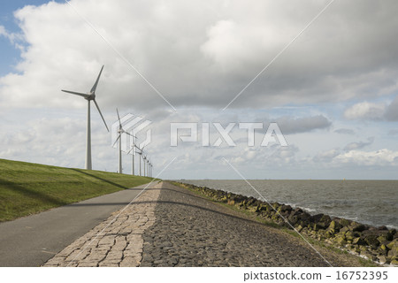 Modern windmills nearby the dike in Netherlands Modern windmills nearby the dike in Netherlands 16752395
