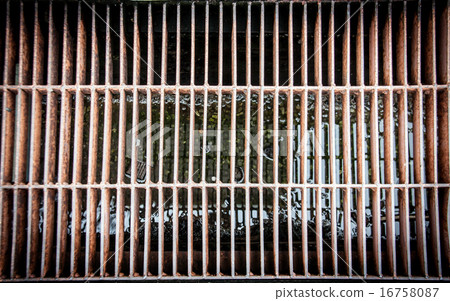dirty and old aligned manhole cover 16758087