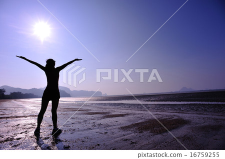 cheering young woman open arms on sunrise beach 16759255