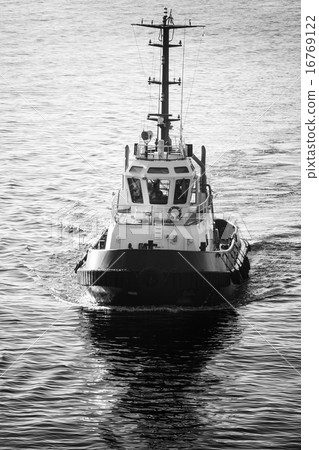 Tug boat underway, front view, black and white 16769122