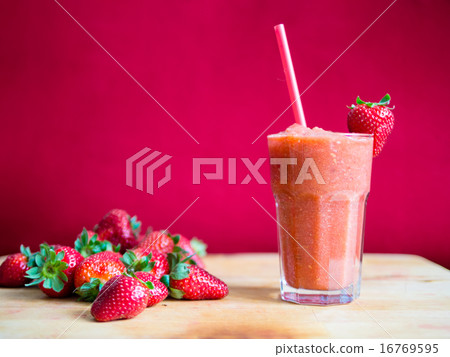 Strawberry smoothie in glass with straw 16769595