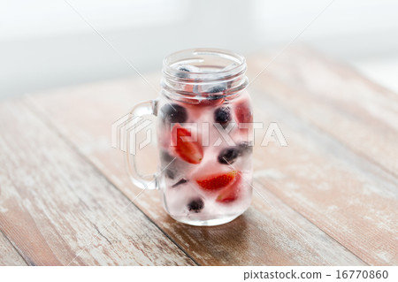 close up of fruit water in glass mug on table close up of fruit water in glass mug on table 16770860
