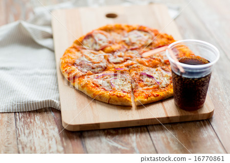 close up of pizza with coca cola on table close up of pizza with coca cola on table 16770861