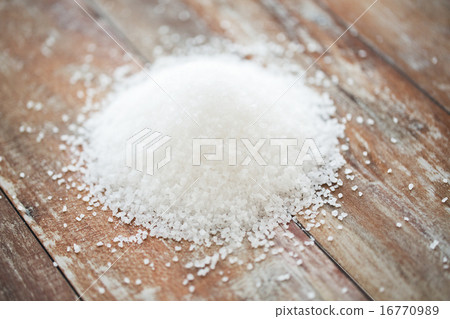 close up of white salt heap on wooden table 16770989