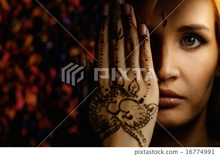 Woman with traditional mehndi henna ornament 16774991