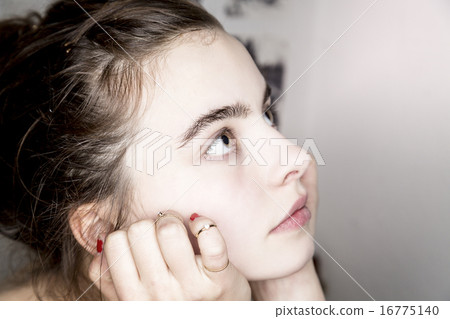 close up portrait of a beautiful young woman 16775140