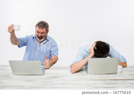 The two colleagues working together at office on white background 16775610