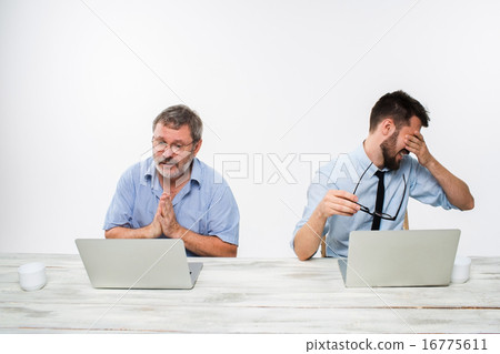 The two colleagues working together at office on white background 16775611