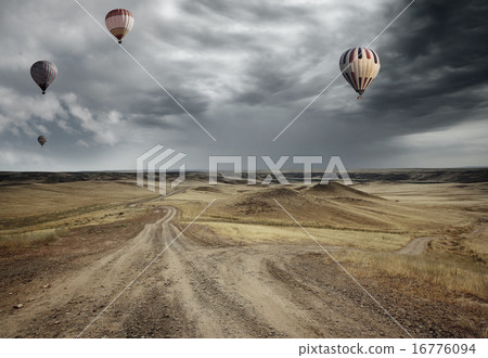 Air balloons over the country road 16776094