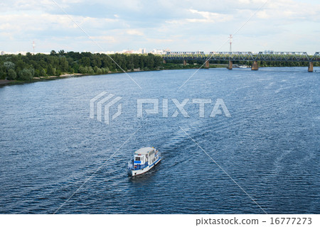 The boat floating in the blue Dnieper waters 16777273