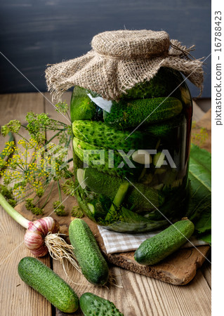 Jar of pickles on wooden table 16788423