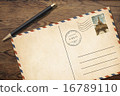 Old vintage postcard with pen on table 16789110