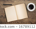 Open diary with pen and coffee cup on old wooden table 16789112
