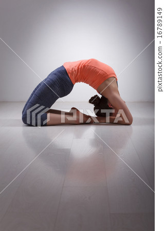 Beautiful sporty fit yogi girl practices yoga asana Kapotasana  16789149