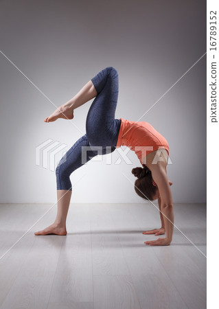 Beautiful sporty fit yogi girl practices yoga asana eka pada cha 16789152
