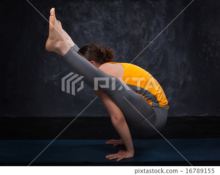 Beautiful sporty fit yogi girl practices yoga asana titibhasana Beautiful sporty fit yogi girl practices yoga asana titibhasana 16789155