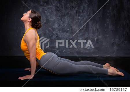 Sporty fit yogini woman practices yoga asana Urdhva mukha svanas Sporty fit yogini woman practices yoga asana Urdhva mukha svanas 16789157