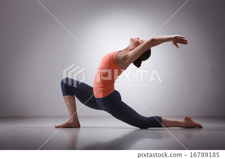 Fit yogini woman practices yoga asana Anjaneyasana Fit yogini woman practices yoga asana Anjaneyasana 16789185