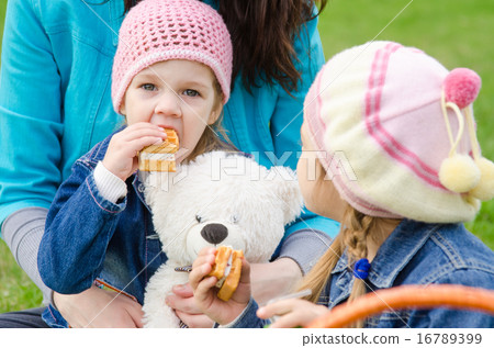 girl sitting on his lap mother eats cake girl sitting on his lap mother eats cake 16789399