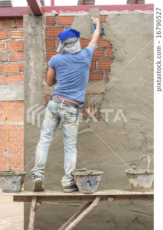 Builder worker plastering concrete at wall Builder worker plastering concrete at wall 16790527