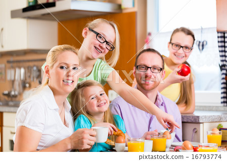 Family having joint breakfast in kitchen 16793774