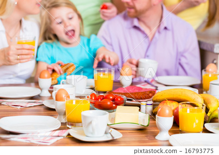 Family having joint breakfast in kitchen Family having joint breakfast in kitchen 16793775